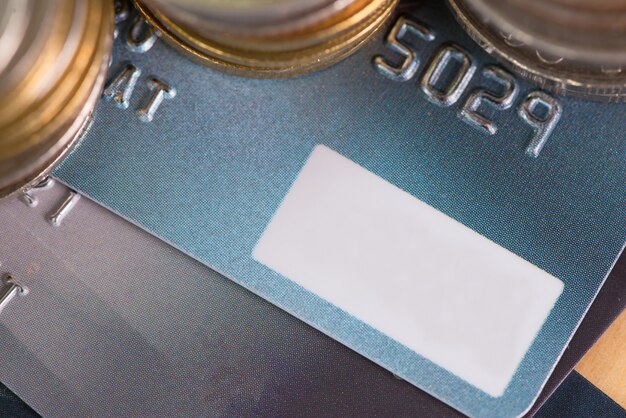 A close-up of a credit card terminal displaying transaction details, surrounded by coins and US currency, symbolizing the cost of processing fees and potential savings.