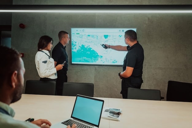 A diverse group of employees participating in a cybersecurity training session, with a presenter showing a slide about insider threat prevention best practices.
