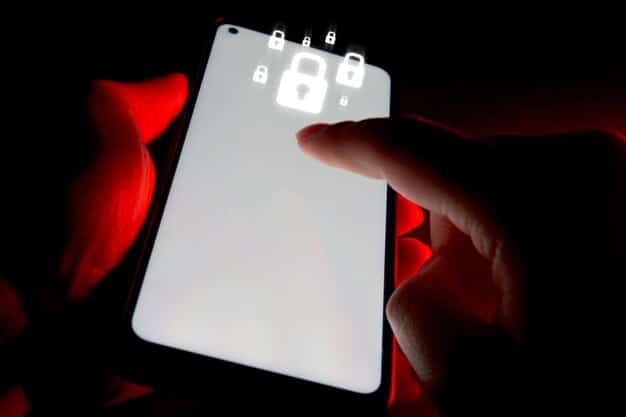 A close-up shot of a smartphone screen displaying a fake login page, with a hacker's silhouette subtly visible in the background. This illustrates the concept of phishing and its potential impact on mobile devices.