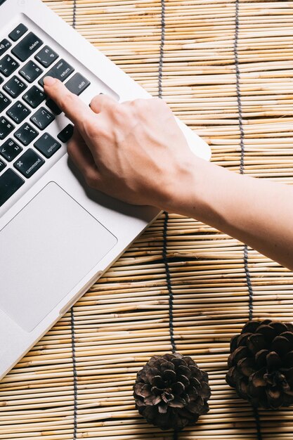 A close-up of hands typing on a laptop keyboard, with a blurred background showing a cybersecurity team working together in a modern office environment. The focus is on the hands typing and the keyboard, suggesting active involvement in data protection.