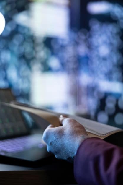 A close-up shot of someone hands coding on a computer, emphasizing the importance of technical skills in the fintech industry. The backdrop includes blurred images of data analytics dashboards.